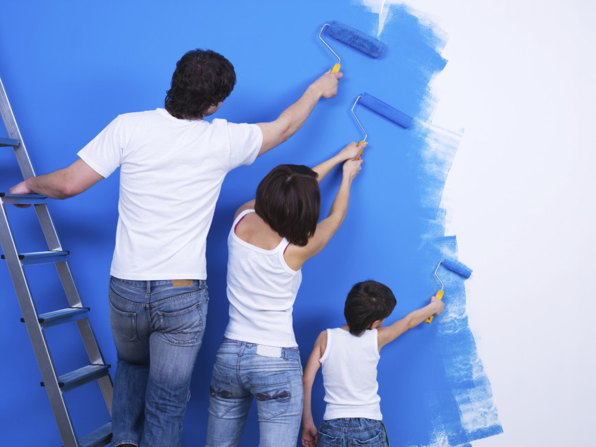 family painting a wall