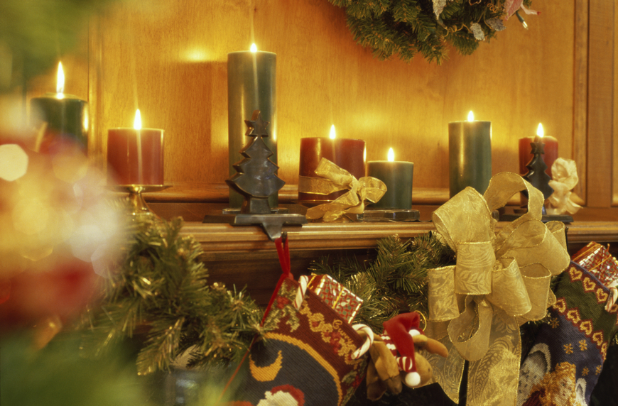 candles and Christmas stockings at fireplace